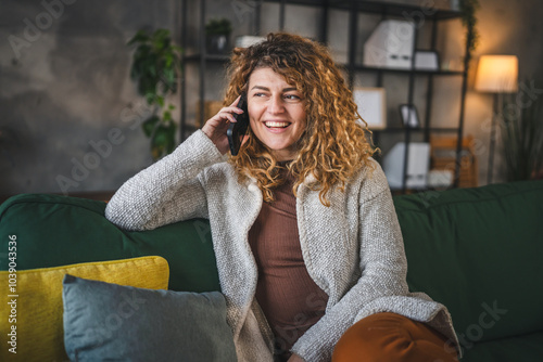 woman with curly hair at home use mobile phone smartphone have a call