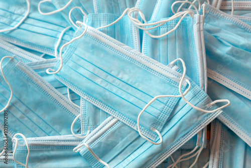 Many sterile medical blue disposable masks. Stack of new medical masks organized.