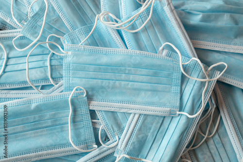 Many sterile medical blue disposable masks. Stack of new medical masks organized.