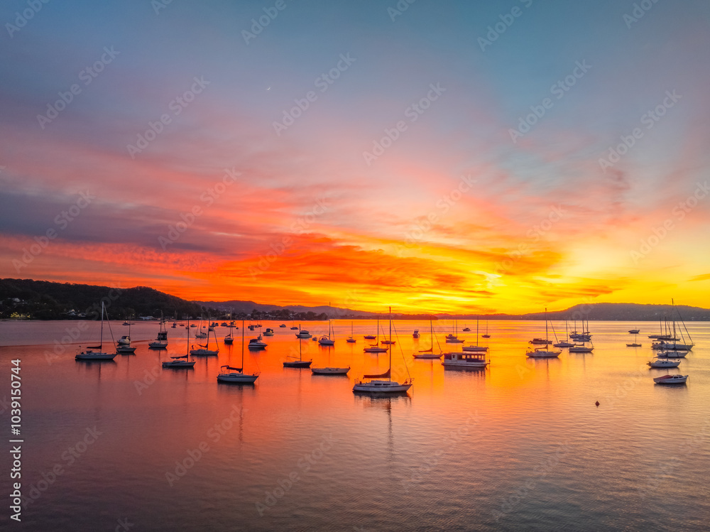 Naklejka premium Aerial sunrise waterscape with boats and high cloud