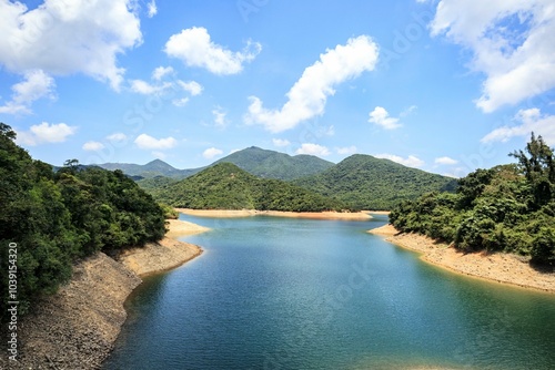 Tranquil Reservoir Surrounded by Lush Green Hills photo