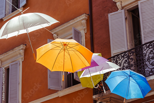 Obraz na płótnie Colorful umbrellas create a vibrant canopy over a charming street in a scenic town of the Modena, Italy, w salonie