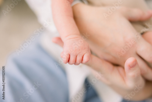 Obraz na plátně A baby is grasping onto his parents' hands