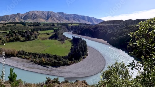 Scenic View of Rakaia Gorge and Turquoise River Winding Through Lush Forests and Steep Cliffs in Canterbury, New Zealand photo