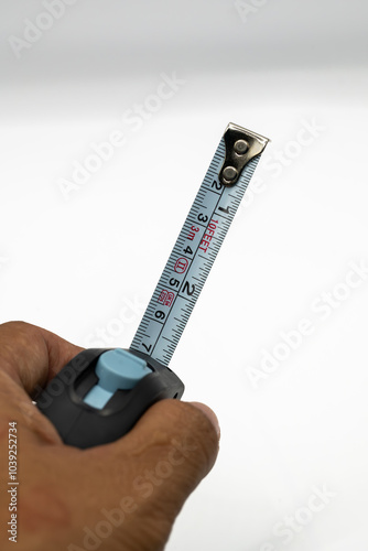 This series of images showcases a classic tape measure, a ubiquitous tool for both professionals and DIY enthusiasts. photo