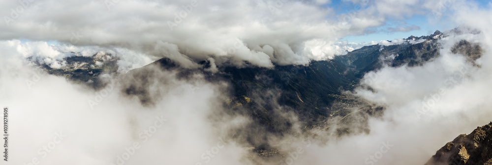 Top view through clouds on valley under Mont Blanc, france normal way to top Top view through clouds on valley under Mont Blanc, france normal way to top