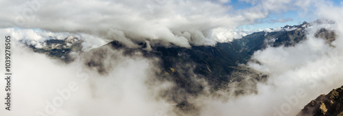 Top view through clouds on valley under Mont Blanc, france normal way to top