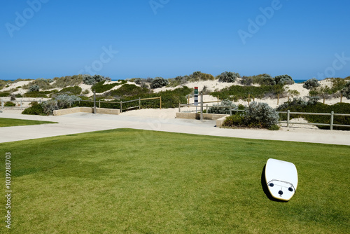 Surf board on the grass in front of the path to Scarborough Beach, Perth, Western Australia photo