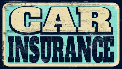 Aged vintage car insurance sign on wood