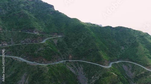 4k drone video of a curvy road high in mountain in northern areas of Pakistan.  photo