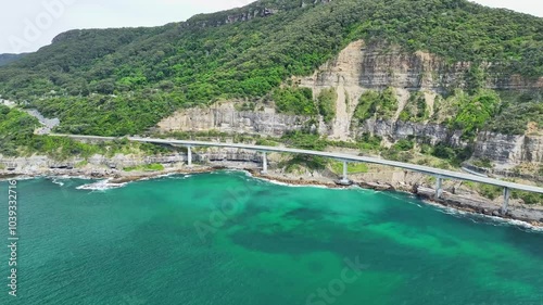 Aerial approaching over the Pacific Ocean towards the Sea Cliff Bridge