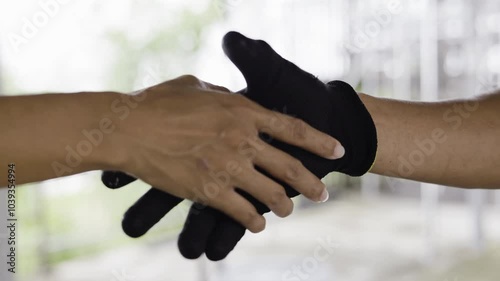 Workers or engineers shaking hands in the factory. Handshake of a builder in a glove with a client.