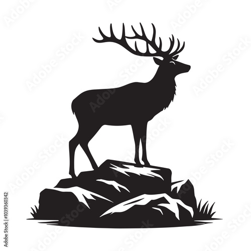 Silhouette of a deer standing on rocks with grass.