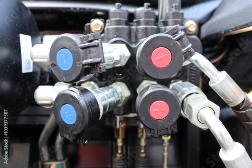 Closeup of a hydraulic valve system with colorcoded connections for easy identification