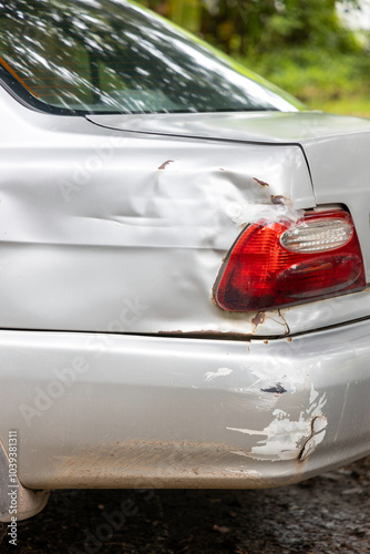 Dreaded scratch down the side car get damaged from accident on the road. Vehicle bumper dent and taillight broken by car crash. Road accidents and car insurance or safety business concept.