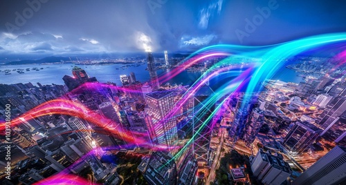 Aerial view of Hong Kong at night with illuminated skyscrapers and colorful streaks of light.