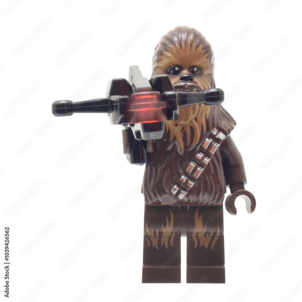 Fototapeta premium Lörrach, Germany -July 15th 2024: Lego minifigure of Chewbacca Star Wars Character with weapon isolated on white. Editorial illustrative image of popular plastic constructor to 25 Anniversary.