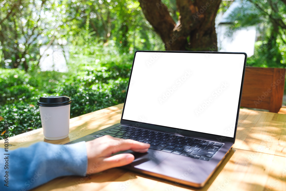 © Farknot Architect - Mockup image of a woman using and touching on laptop computer touchpad with blank white desktop screen in the outdoors © Farknot Architect - Mockup image of a woman using and touching on laptop computer touchpad with blank white desktop screen in the outdoors