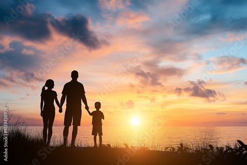 Silhouette of a family holding hands at sunset by the ocean, with space for text. Parents and children enjoy a beautiful sunset over the sea.