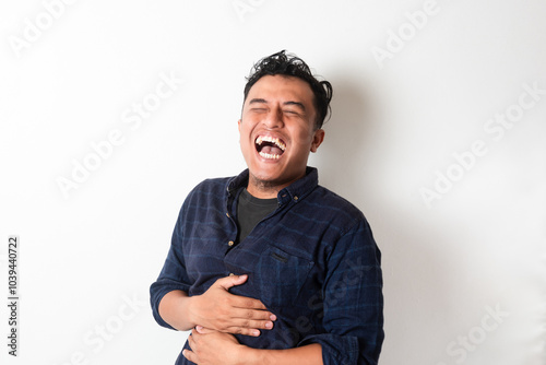 Konstfotografi Adult Asian man laughing out loud while holding his stomach