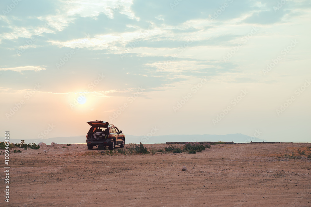 SUV car at sandy beach of Aegean sea in summer morning SUV car at sandy beach of Aegean sea in summer morning