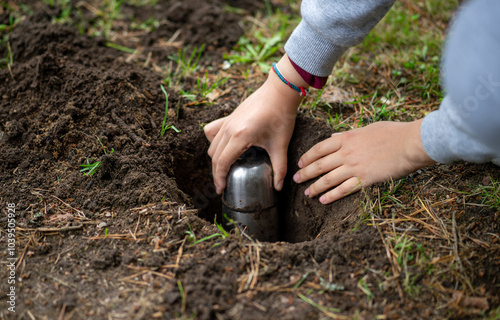A time capsule buried in the ground. A message to posterity in a bottle. Unexpected finds in the forest. photo