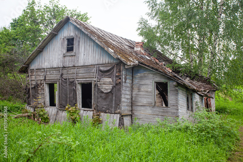 An old abandoned village.A wooden house falls on its side.Devastation.Unsuitable housing.