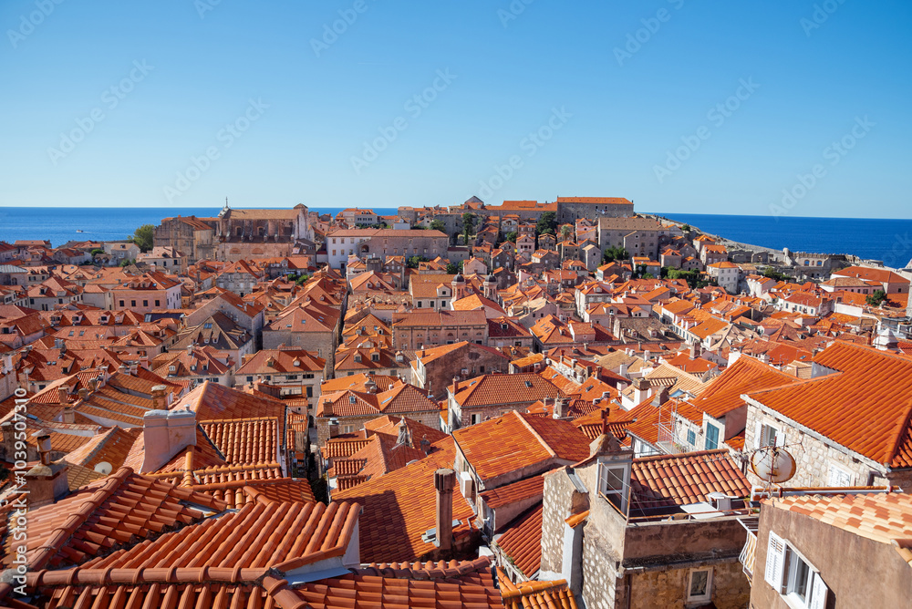 panoramic view of old town Dubrovnik, Croatia, showing terracotta rooftops, ancient architecture, the Mediterranean Sea, and ancient fortifications. Dalmatian coast. panoramic view of old town Dubrovnik, Croatia, showing terracotta rooftops, ancient architecture, the Mediterranean Sea, and ancient fortifications. Dalmatian coast.
