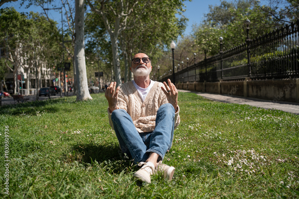 Senior man doing yoga on grass in park Senior man doing yoga on grass in park