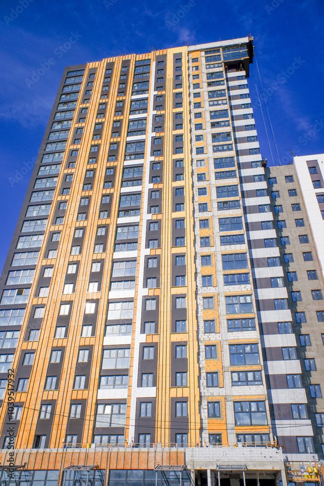 A large building with a brown facade and a lot of windows A large building with a brown facade and a lot of windows