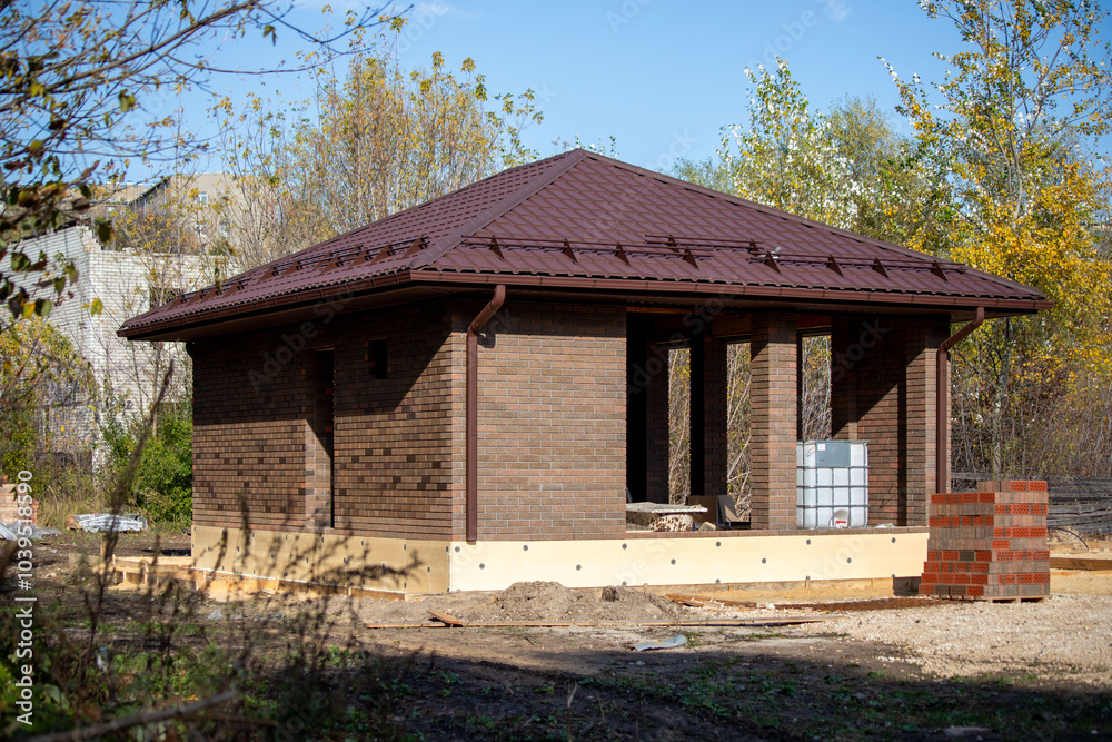A small house is being built in a wooded area A small house is being built in a wooded area