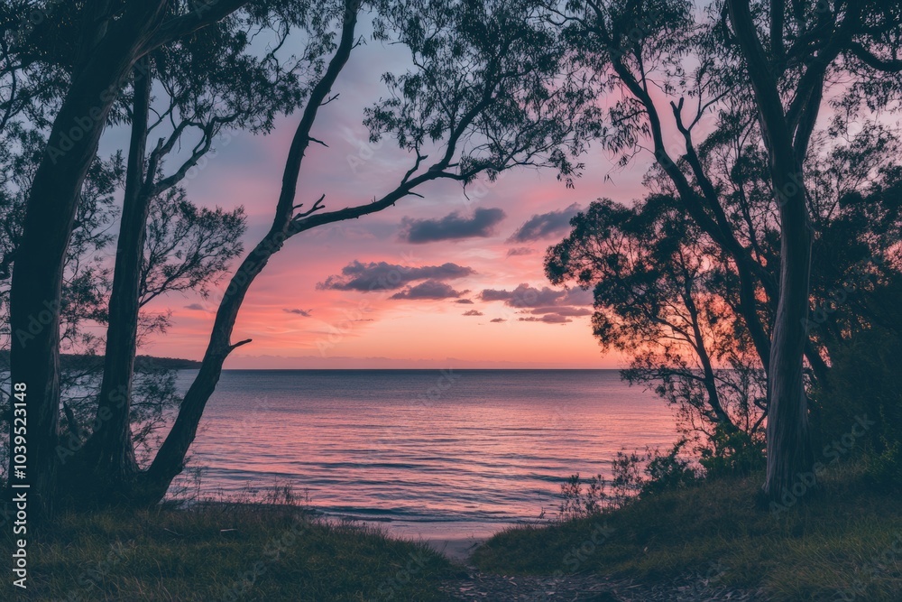 A serene view of pastel-colored skies overlooking a calm ocean, framed by silhouetted trees, creating a tranquil and idyllic natural landscape at dusk. A serene view of pastel-colored skies overlooking a calm ocean, framed by silhouetted trees, creating a tranquil and idyllic natural landscape at dusk.