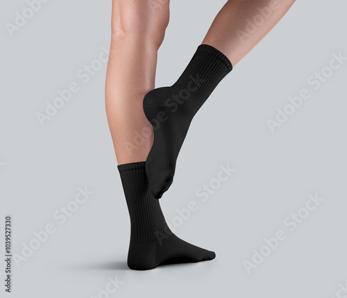 Mockup of black high socks with elastic band on female slender legs, one ankle stretched, side view, isolated on background. photo