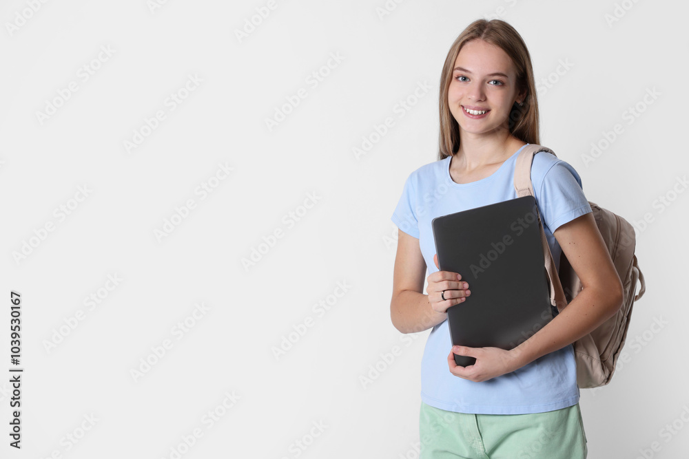 Teenage girl with laptop and backpack on white background, space for text Teenage girl with laptop and backpack on white background, space for text