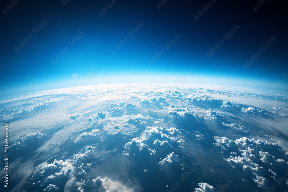 This striking image depicts Earth's horizon visible from space, with a captivating curve formed by white clouds suspended over the brilliant blue atmosphere. This striking image depicts Earth's horizon visible from space, with a captivating curve formed by white clouds suspended over the brilliant blue atmosphere.