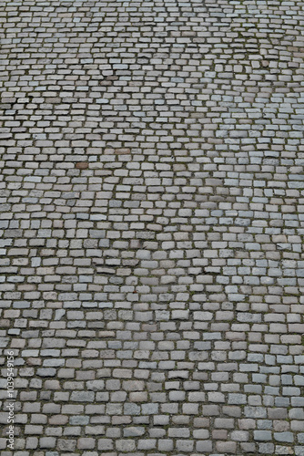 Background of cobblestone. Architecture background with stone cladding road. Concrete tiles background. Stone road background for poster or banner.