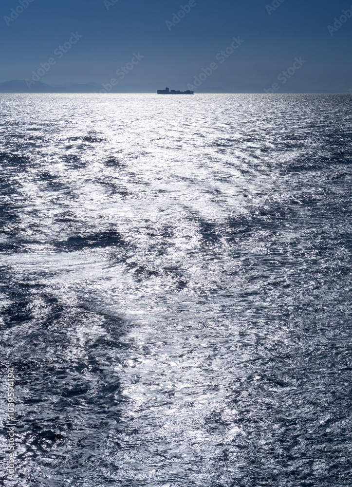 Fototapeta premium A ship on the horizon in the Aegean Sea in Greece
