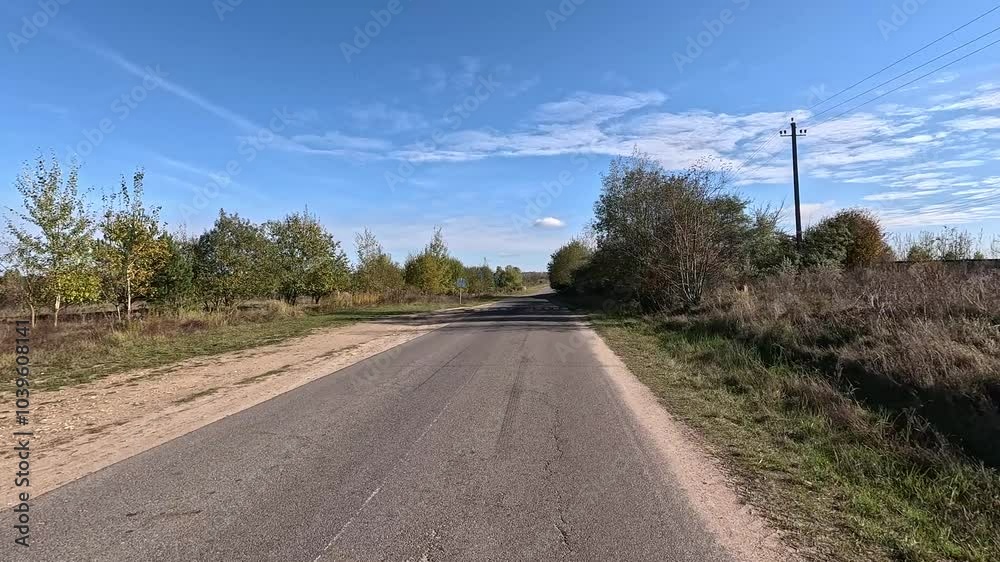 Autumn landscape and view of the road in motion. Driving a car on the road at speed. Asphalt and white road markings. Autumn landscape and view of the road in motion. Driving a car on the road at speed. Asphalt and white road markings.