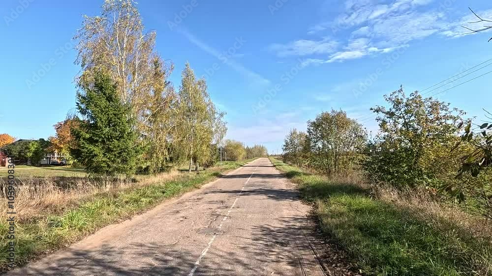 Autumn landscape and view of the road in motion. Driving a car on the road at speed. Asphalt and white road markings. Autumn landscape and view of the road in motion. Driving a car on the road at speed. Asphalt and white road markings.