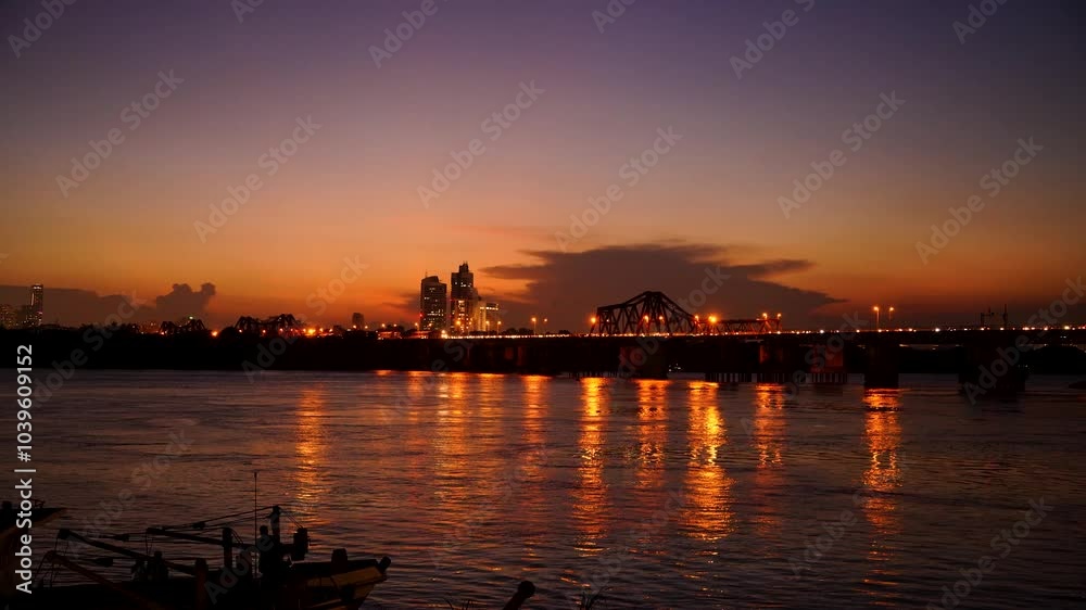 Beautiful sunset view of Long Bien bridge over Hong river (or Red river) that connects two districts, Hoan Kiem and Long Bien in Hanoi city, Vietnam. Beautiful sunset view of Long Bien bridge over Hong river (or Red river) that connects two districts, Hoan Kiem and Long Bien in Hanoi city, Vietnam.