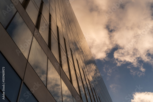 Wallpaper Mural Windows of building at sunset. Reflection of the sky in the window glass. Skyscrapers in business district against blue sky. Looking up high-rise office buildings. Angled view. Torontodigital.ca