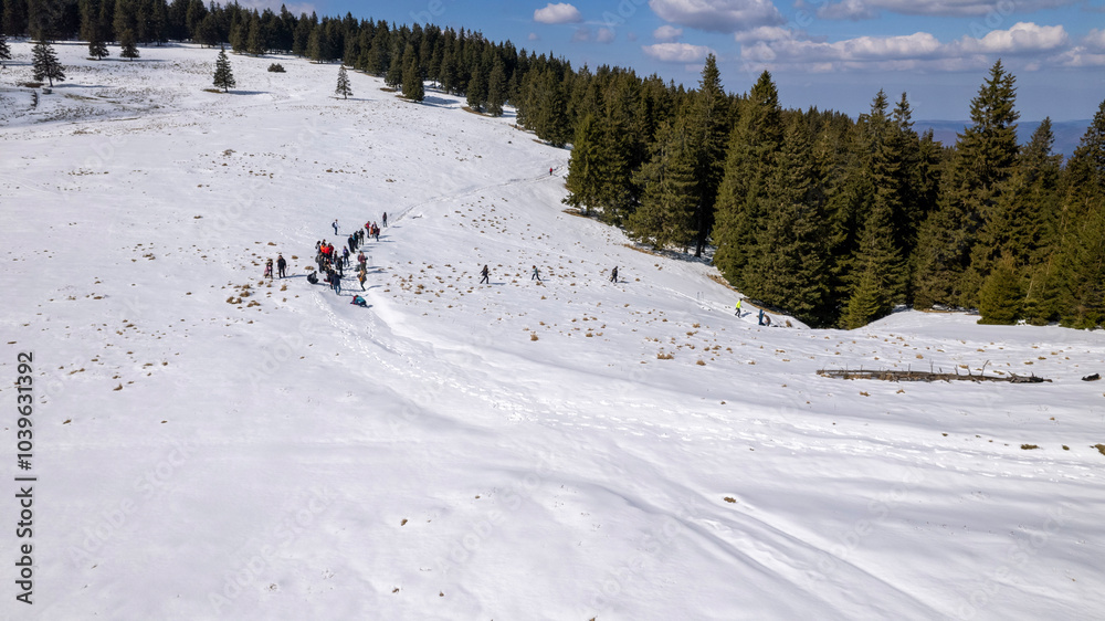 Fototapeta premium Snow hike with lots of people on a mountain, Romania, Lacul Vulturilor, Mălâia