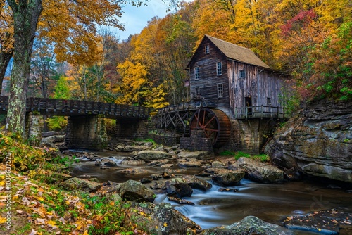 Old wooden mill by a stream in autumn, surrounded by colorful foliage. Babcock State Park, WV photo