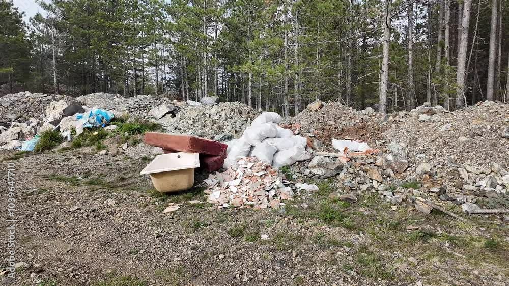 Discarded construction debris in a forest clearing highlights environmental pollution, waste management issues Discarded construction debris in a forest clearing highlights environmental pollution, waste management issues