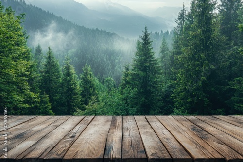 Serene forest landscape with misty mountains and wooden deck during early morning