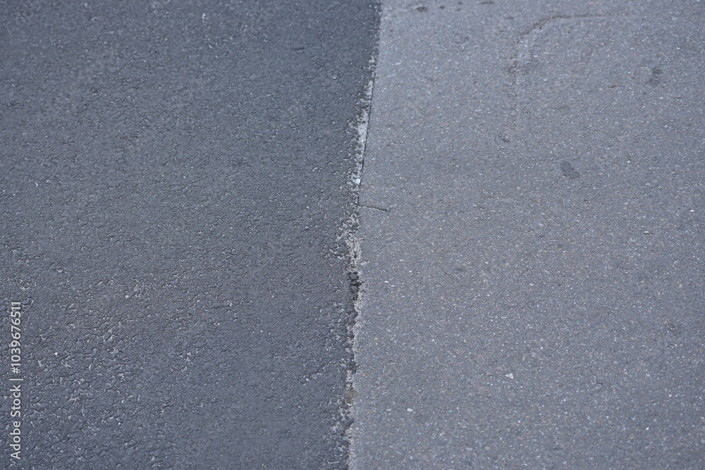 dark grey and light grey asphalt, junction of new and old road surfaces, repaired roadway dark grey and light grey asphalt, junction of new and old road surfaces, repaired roadway