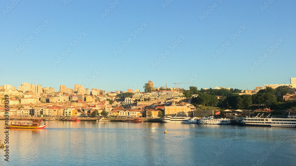 A picturesque view of Porto's Ribeira district with boats on the Douro River, ideal for a holiday getaway A picturesque view of Porto's Ribeira district with boats on the Douro River, ideal for a holiday getaway