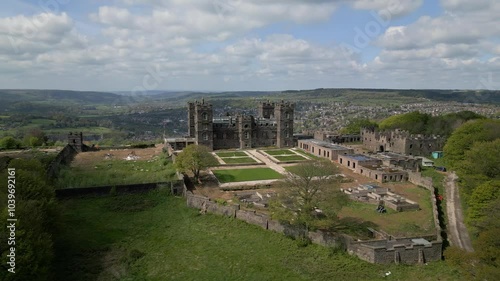 Drone shot around Riber castle at Matlock, Derbyshire with green landscape and cloudy sky photo