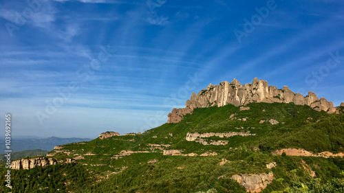 A stunning view of Montserrat mountain under a vibrant blue sky, perfect for travel inspiration and nature exploration in Catalonia