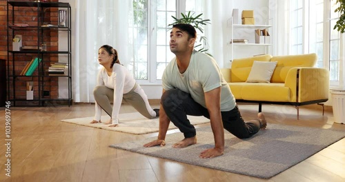 Indian Asian young couple joyfully practicing yoga together in their lavish home, executing Ek Pad Prasarita Padasana, or One-Legged Wide-Legged Forward Bend pose photo